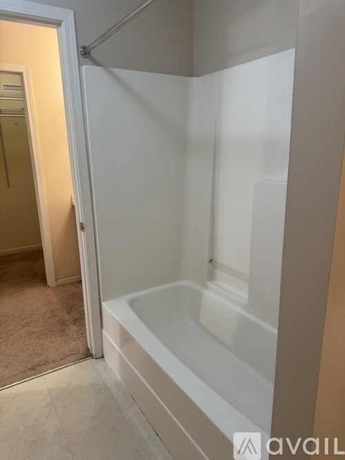 A bathroom with a white tub and a walk-in shower.
