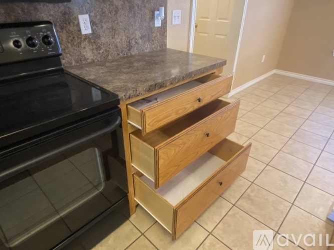 A kitchen with a black oven and a granite countertop.