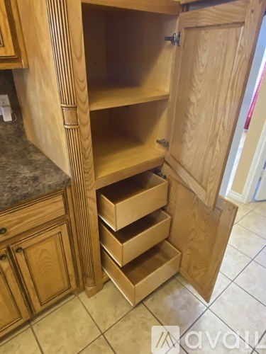 A kitchen with wooden cabinets and drawers.