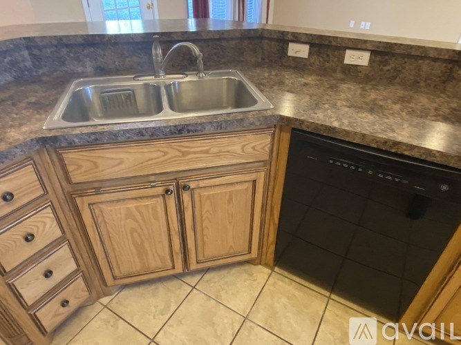 A kitchen with a sink and a dishwasher.