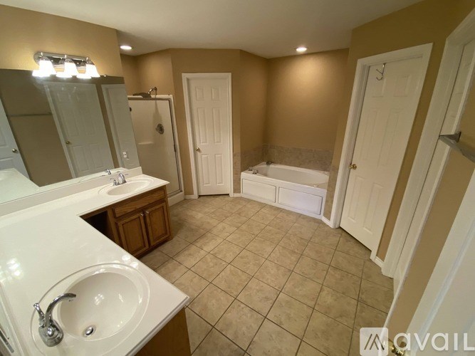 A bathroom with a white sink and a bathtub.