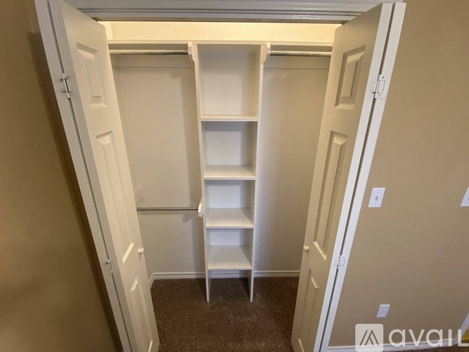 A small white shelf unit in a room.