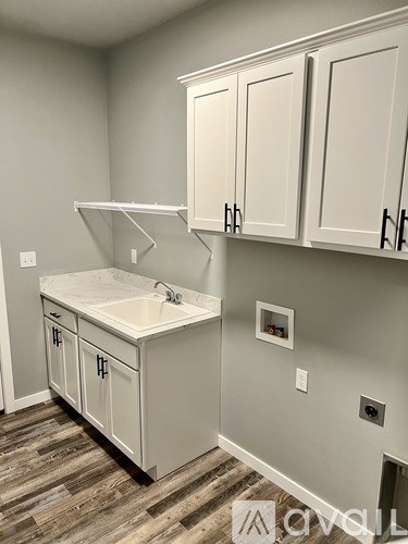 A bathroom with a sink and cabinets.