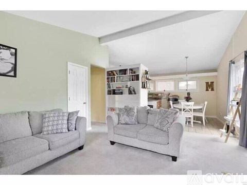 A living room with a grey couch and a grey sofa.