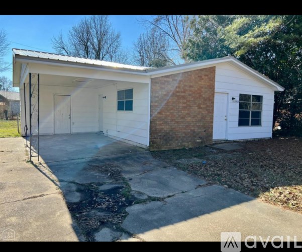 A small white house with a brick chimney is for sale.