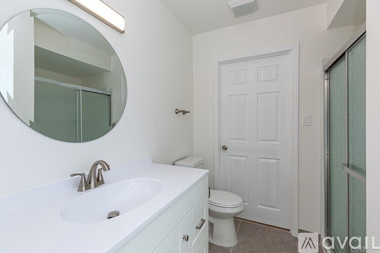 A bathroom with a white toilet and sink.