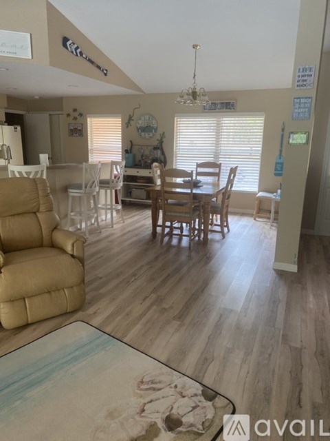 A living room with a dining table and chairs.