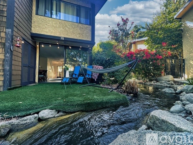 A modern house with a small stream running in front of it.