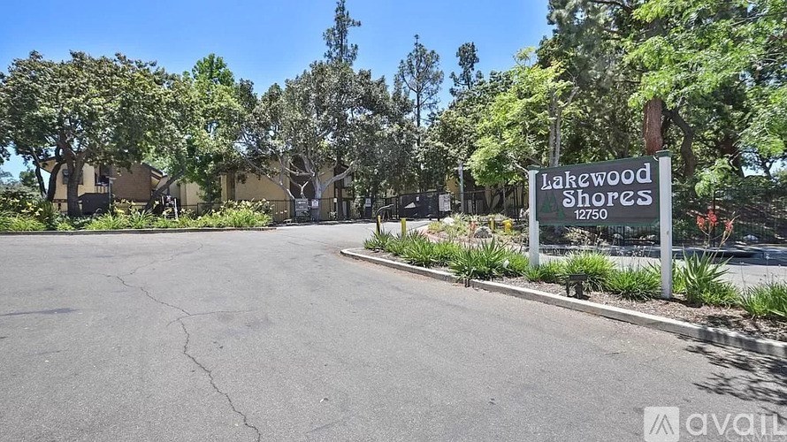 A sign for Lakewood Shores is in front of a parking lot.