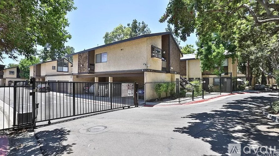A gated community with apartment buildings and a clear sky.