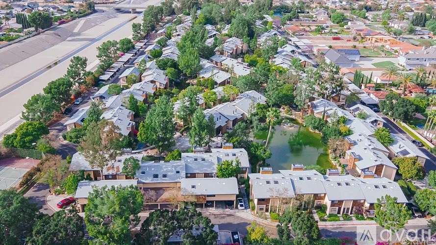 A bird's eye view of a residential area with houses and trees.