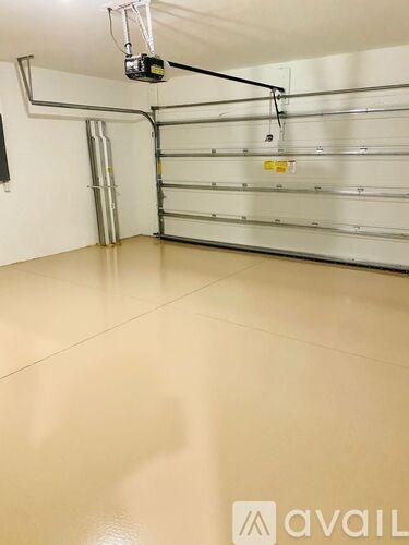 A garage with a wall-mounted bike rack and a wall-mounted light fixture.