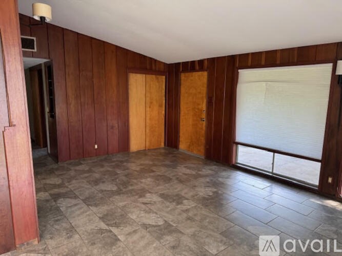A room with wooden walls and a tiled floor.