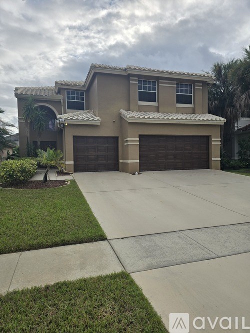 A house with a brown garage door and a beige exterior.