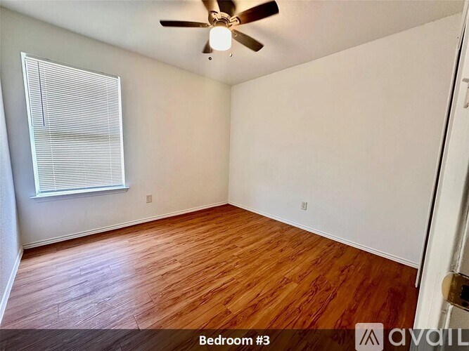 Bedroom #3 has hardwood floors and a ceiling fan.
