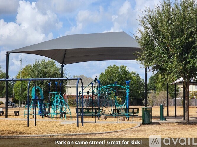 A playground with a canopy and a slide.