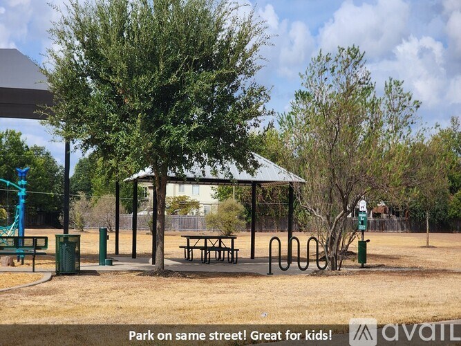 A park with a pavilion, playground, and picnic tables.