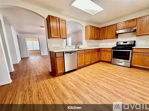 A kitchen with wooden cabinets and a stove top oven.