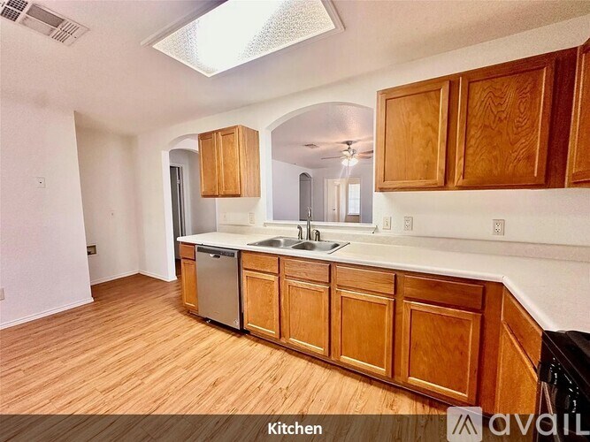 A kitchen with wooden cabinets and a dishwasher.