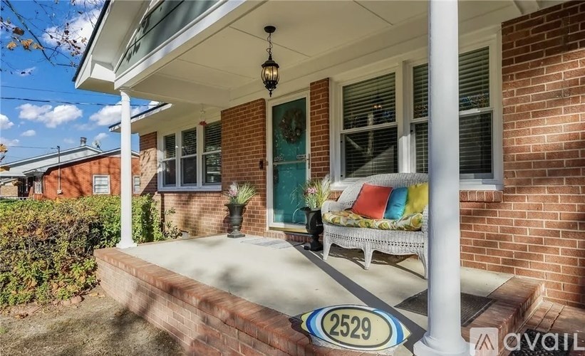 A house numbered 2529 with a white porch and a hanging light fixture.