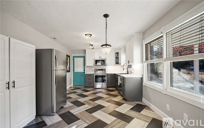 A kitchen with a black and white checkered floor.