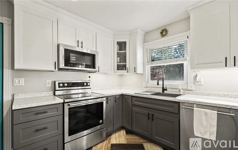 A kitchen with a stove, oven, and cabinets.