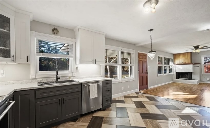 A kitchen with dark cabinets and a checkered floor.