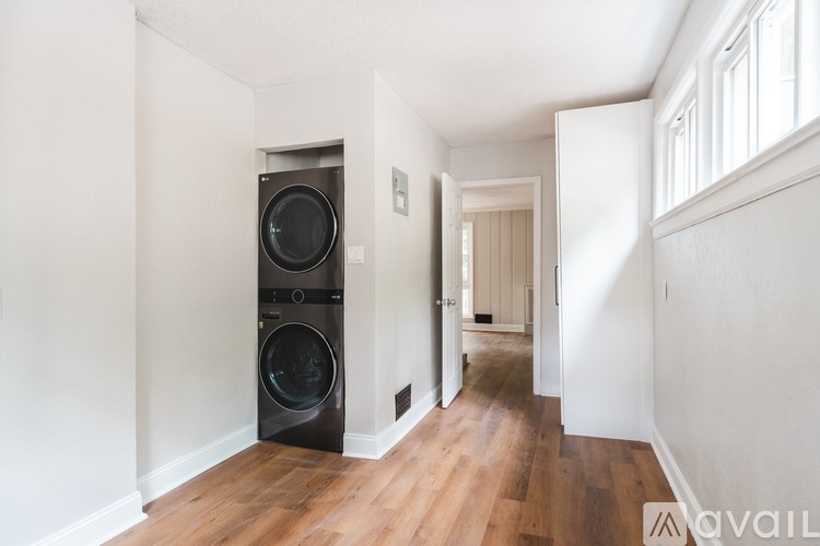 A modern laundry room with a washer and dryer built into the wall.