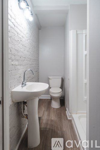 A white sink and toilet in a small bathroom.