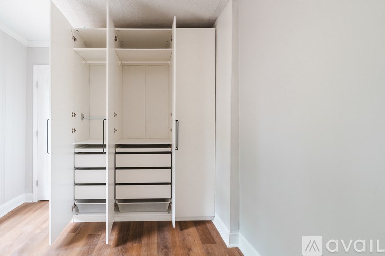 A white closet with shelves and a hanging rod.