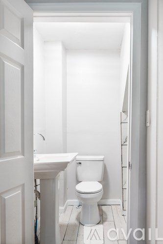 A white bathroom with a toilet and sink.