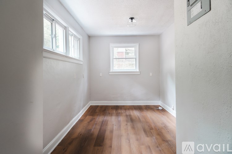 A room with wooden floors and a window.