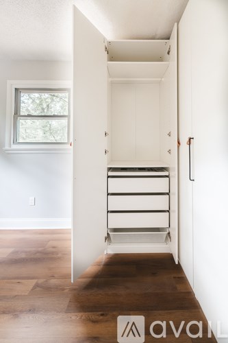 A white door with a handle is open.