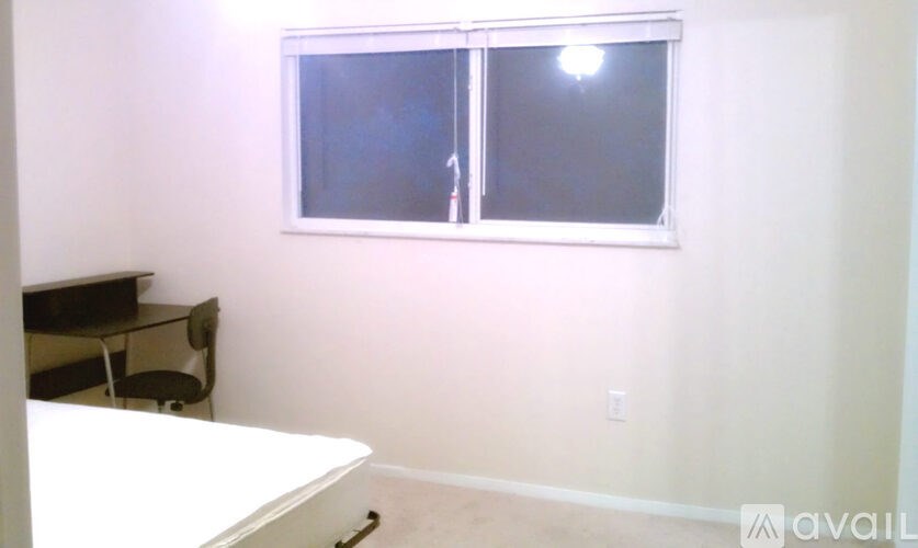 A room with a desk and a window.