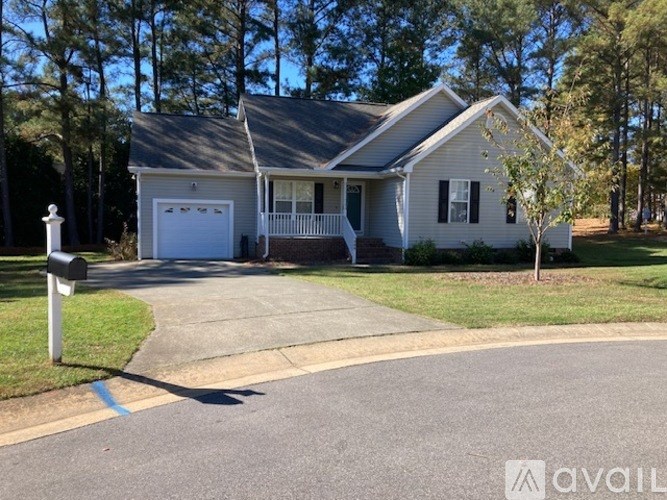 A house with a white garage door is for sale.