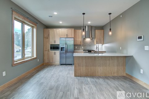 A modern kitchen with wooden cabinets and a large island.