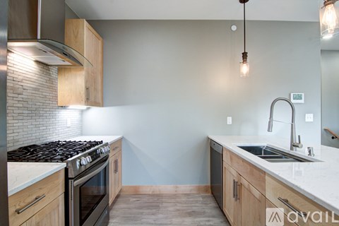 A kitchen with a stove top oven and a sink.