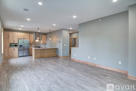 A spacious kitchen with wooden cabinets and a central island.