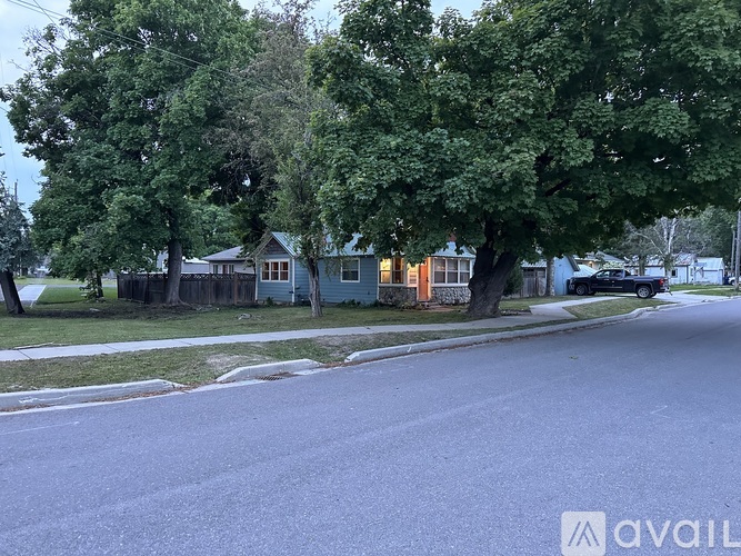 A street view with houses and trees.