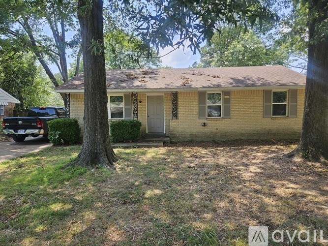 A house with a tree in front of it.