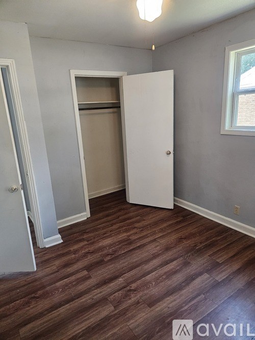 A room with a white door and a window.