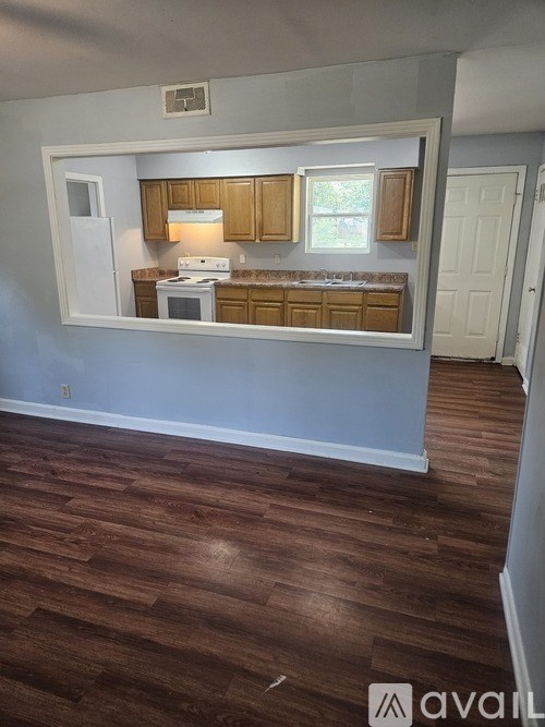 A kitchen with wooden cabinets and a white fridge.