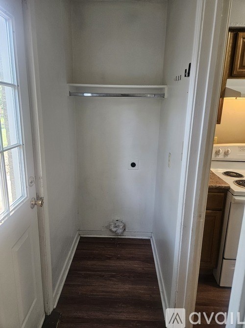 A small white room with a door and a window.