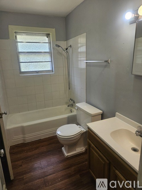 A bathroom with a toilet, sink, and bathtub.