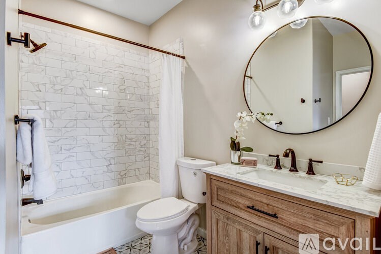 A hallway with a tiled floor and a wooden cabinet.