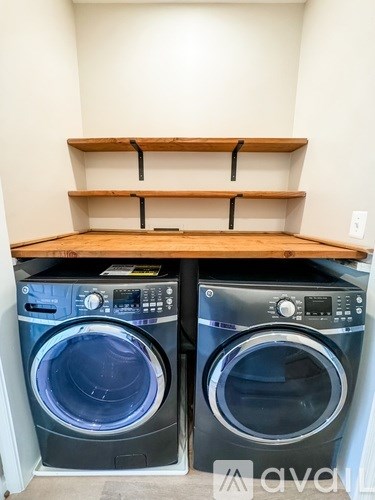 Two front loading washing machines in a laundry room.