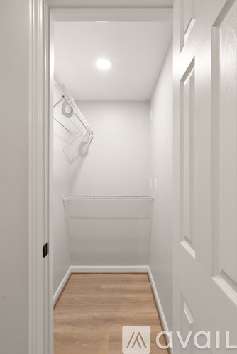 A hallway with a light on the ceiling and a door on the right.