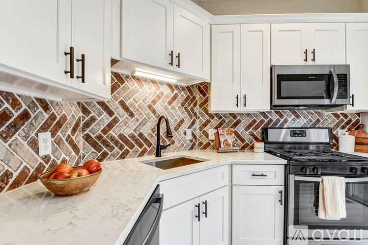 A silver car is parked in front of a two-story house with a garage.