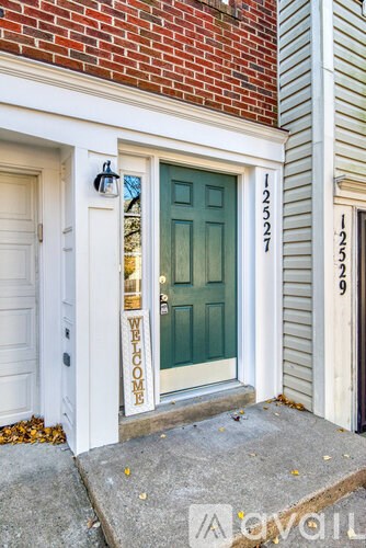 A wooden staircase with a chandelier hanging above it.