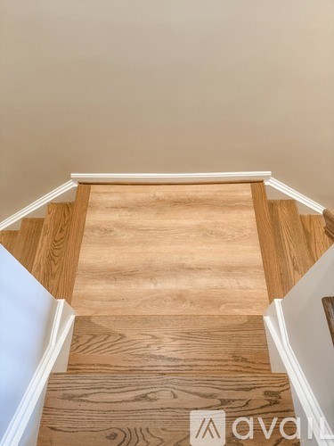 A wooden staircase with white trim.